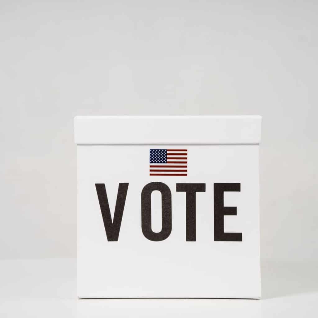 A photo of a white box with an American flag and the word "vote" on the front.